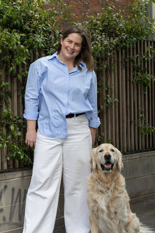 Fiona with her golden retriever, Dusty, outdoors.